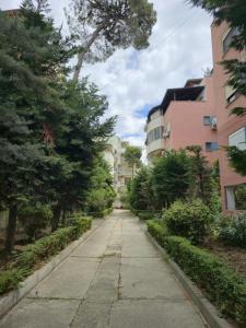 an empty sidewalk in a city with buildings at A&B Seaside Residence in Golem