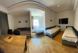 a living room with two beds and a couch at Pokoje Gościnne Pocztacaffe in Gdynia