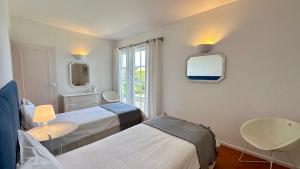 a hospital room with two beds and a mirror at Dunas - Private Pool - 8 Guests - Albufeira in Albufeira