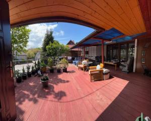 a deck with plants and furniture on a house at Pokoje Gościnne Pocztacaffe in Gdynia