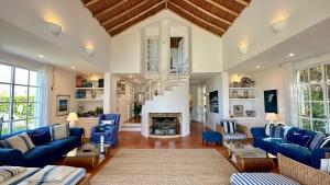 a living room with blue couches and a fireplace at Dunas - Private Pool - 8 Guests - Albufeira in Albufeira