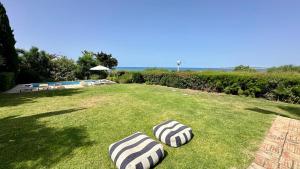 two beach umbrellas on the grass in a yard at Dunas - Private Pool - 8 Guests - Albufeira in Albufeira +41 photos