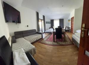 a living room with a couch and a tv at Pokoje Gościnne Pocztacaffe in Gdynia +11 photos