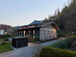 a house on a hill with a driveway at berge I Design-Quartiere in Aschau im Chiemgau