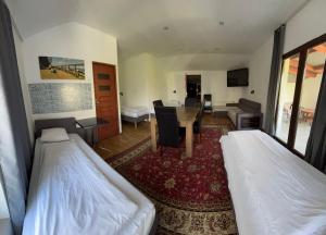 a room with two beds and a dining room at Pokoje Gościnne Pocztacaffe in Gdynia