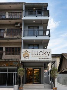 a building with a sign for a luxury hotel at Lucky Hostel in Vientiane