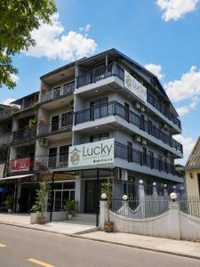 a building with a sign for a lucky restaurant at Lucky Hostel in Vientiane