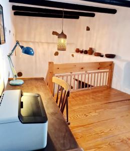 a room with a table and a lamp and a crib at Luana House in Teguise