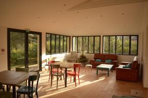 a living room with a table and chairs at Tagar'étape in Étables-sur-Mer