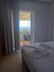 a bedroom with a bed and a view of a balcony at Villa Klaus in Lukovë