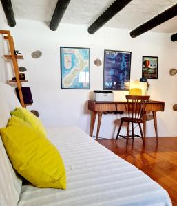 a bedroom with a bed and a desk at Luana House in Teguise