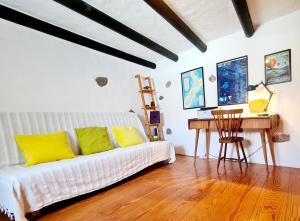 a living room with a white couch and a desk at Luana House in Teguise