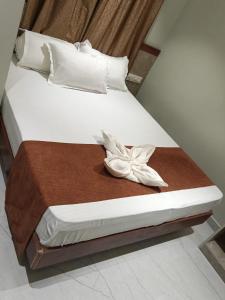 a bedroom with a bed with a flower on it at Shri Guru Prasad in Belgaum