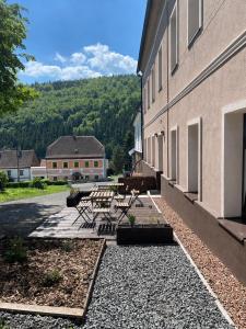 a patio with a table and benches next to a building at Apartmány Mikulov 45 in Mikulov v Krušných Horách