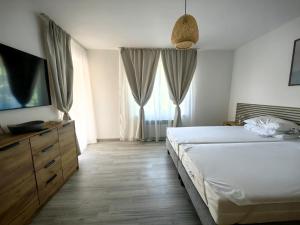 a bedroom with two beds and a flat screen tv at Villa Mario Verde in Punat