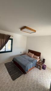 a bedroom with a bed in a white room at Authentic Cozy Chalet Near the Beach in Ras Sedr +12 photos