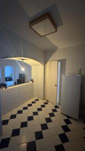 a kitchen with a checkered floor and a refrigerator at Authentic Cozy Chalet Near the Beach in Ras Sedr