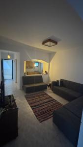 a living room with two couches and a rug at Authentic Cozy Chalet Near the Beach in Ras Sedr
