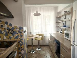 a kitchen with a small table and a window at Villa Mario Verde in Punat