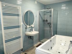 a bathroom with a tub and a sink and a mirror at Villa Mario Verde in Punat +71 photos