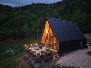 a small house with a black roof on a field at Hyde Retreat in Holda