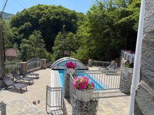a pool with chairs and flowers on a fence at Ластівчине гніздо in Shaian