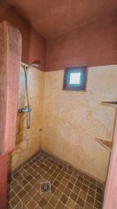 a bathroom with a shower and a window at merzouga stars luxury camp in Merzouga +20 photos