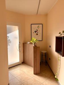 a room with a door and a table and a television at Il Fico Lake Iseo b&b in Iseo