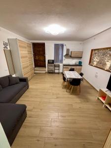 a living room with a couch and a table at Appartamento Osnao in Cefalù