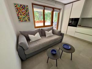 a living room with a couch and two tables at Ankaran Studio Escape in Ankaran