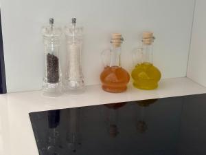 a row of glass bottles sitting on a shelf at Ankaran Studio Escape in Ankaran +22 photos