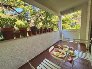 a table with a plate of food on a balcony at Ankaran Studio Escape in Ankaran