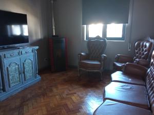 a living room with two chairs and a television at Meda`s House in Meda