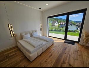 a large bed in a room with a large window at Alpine Loft in Kapfenberg