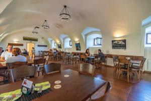 a group of people sitting at tables in a restaurant at Hospoda na sýpce in Kuks +28 photos