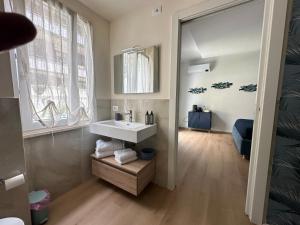 a bathroom with a white sink and a mirror at ComfortHouse AlbatrosMare in Ladispoli +101 photos
