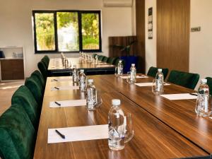 a conference room with a long table with chairs and a bottle of water at Spektr Boutique Hotel Yalikavak in Yalıkavak +141 photos
