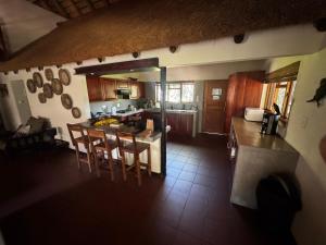 an aerial view of a kitchen with a table and chairs at Spacious Family Villa, close to Krugerpark entrance in Phalaborwa