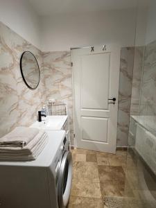 a bathroom with a toilet and a sink and a mirror at Studio Factory 22 in Braşov +7 photos