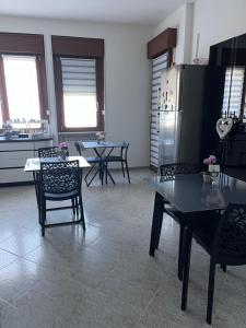 a kitchen with a table and chairs and a refrigerator at B&B a casa di Sonia in Termoli