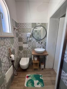 a bathroom with a sink and a toilet and a mirror at B&B Santa Maria Di Leuca in Leuca +93 photos