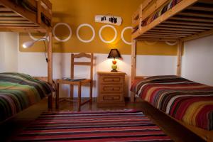 a bedroom with two bunk beds and a ladder at Hostel Seixe in Odeceixe