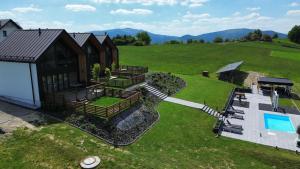 an aerial view of a house with a swimming pool at Lipowe Apartmenty in Limanowa