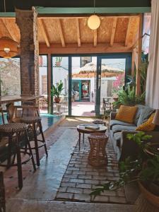 a patio with a couch and chairs and a table at Casa Barreres in Moncada