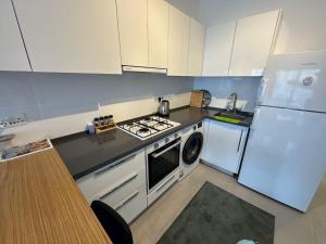 a small kitchen with a stove and a refrigerator at Caesar Resort SPA in Iskele