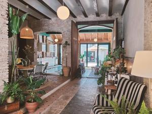 a restaurant with plants and chairs in a room at Casa Barreres in Moncada