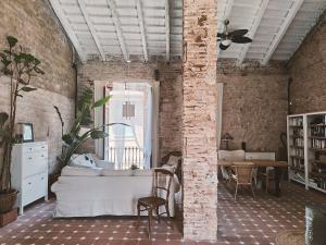 a living room with a white couch and a brick wall at Casa Barreres in Moncada +65 photos