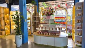 a store with a shelf with products on it at SHARE Hostel & Coffee in Hue
