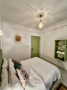a bedroom with a bed and a couch at Cozy Flat With Pool Near The Beach TAMRAGHT -APP13 in Tamraght Ouzdar