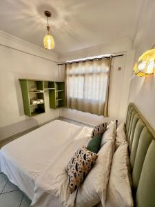 a large bed in a room with a couch at Cozy Flat With Pool Near The Beach TAMRAGHT -APP13 in Tamraght Ouzdar
